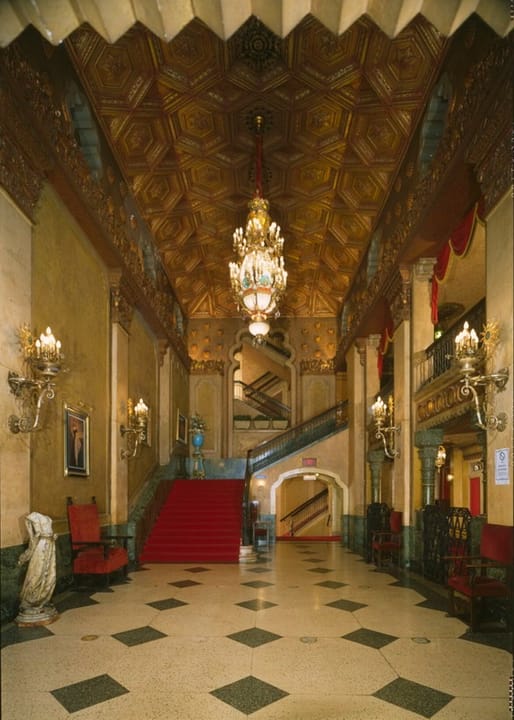 The Alabama Theatre's grand lobby, with its checkerboard marble floor, coffered gilt ceiling and red-carpeted stair, Birmingham, Alabama, 1996.