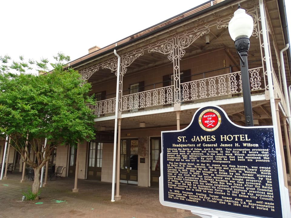 The St. James Hotel's cast-iron gallery facade with its historical marker, which reads "St. James Hotel, Headquarters of General James H. Wilson."