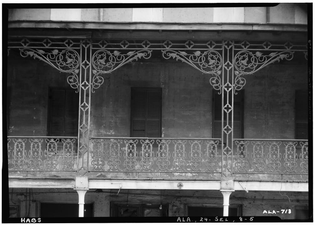A black-and-white Historic American Buildings Survey photograph of the St. James Hotel's cast-iron gallery ironwork detail.