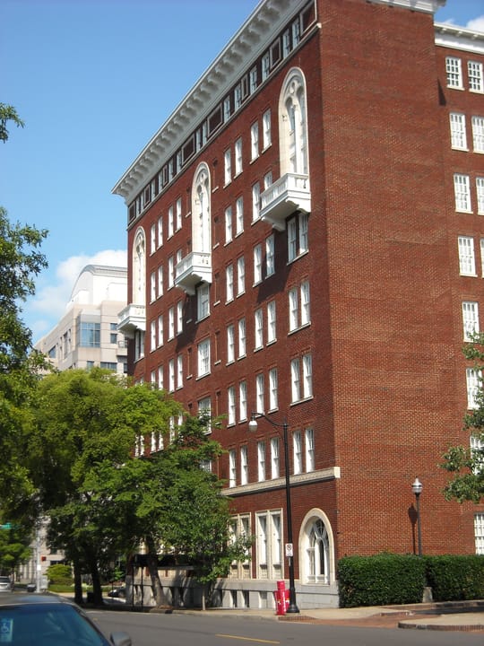 A street-level diagonal view of the Tutwiler Hotel's red-brick facade among downtown Birmingham trees, August 2009.