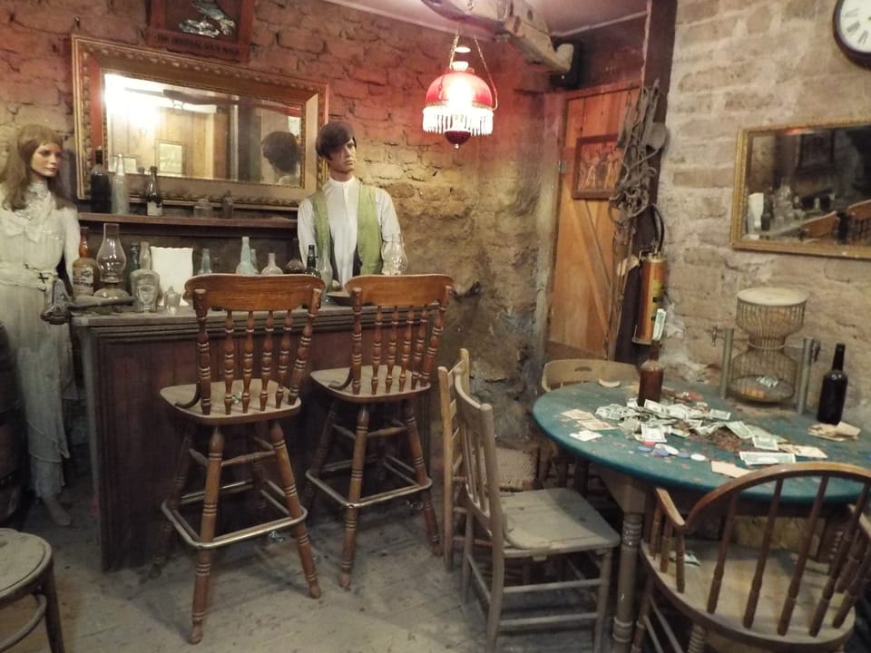 A re-created bar and gambling area in the Bird Cage Theatre's basement, Tombstone, Arizona, furnished with period pieces and costumed display figures.