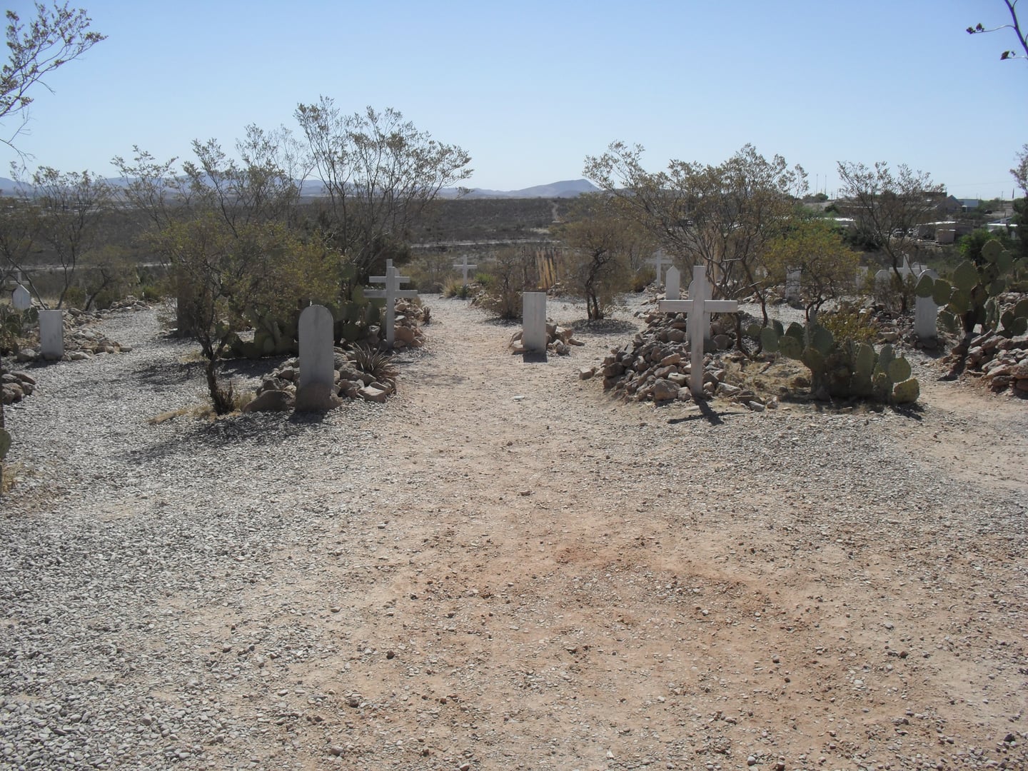 Overall view of Boothill Graveyard with rock-piled graves and wooden markers above Tombstone, Arizona