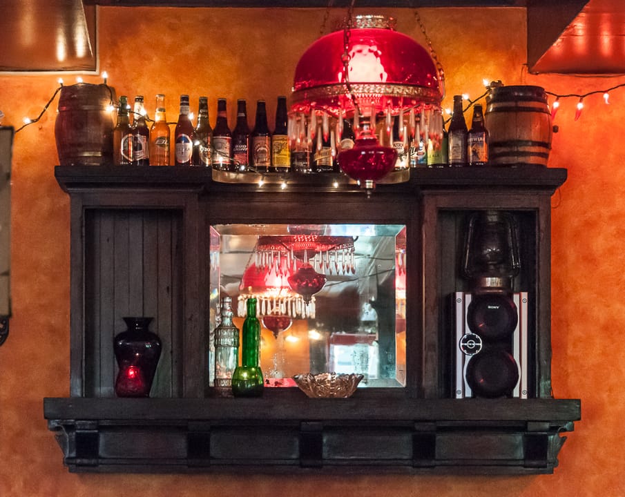 The back bar of the Copper Queen Saloon, inside the Copper Queen Hotel, Bisbee, Arizona, with bottles and a mirrored back-bar.