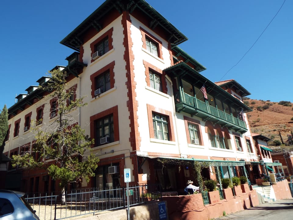 A full daytime exterior view of the Copper Queen Hotel's east facade and street frontage, Bisbee, Arizona.