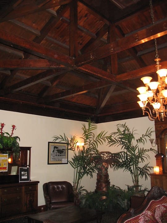 The Copper Queen Hotel's lobby sitting area, with a wood-beamed ceiling, chandelier and period furnishings, Bisbee, Arizona.