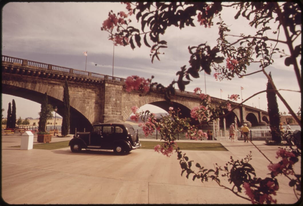 The bridge in Lake Havasu City, Arizona, photographed in May 1972 -- within a year of its October 1971 dedication -- for the EPA's DOCUMERICA program, with a period car parked on the span.