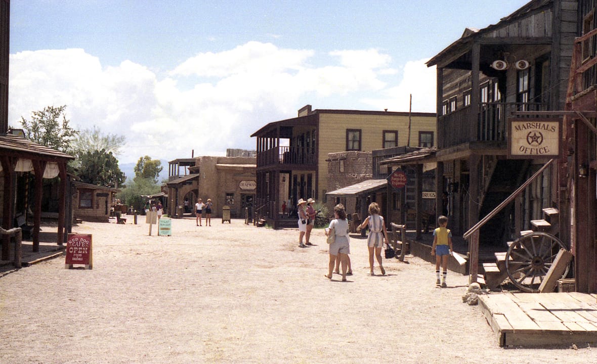 Visitors walk the Western Street set at Old Tucson Studios, Tucson, Arizona, 13 August 1984, more than a decade before the 1995 arson fire and reconstruction.