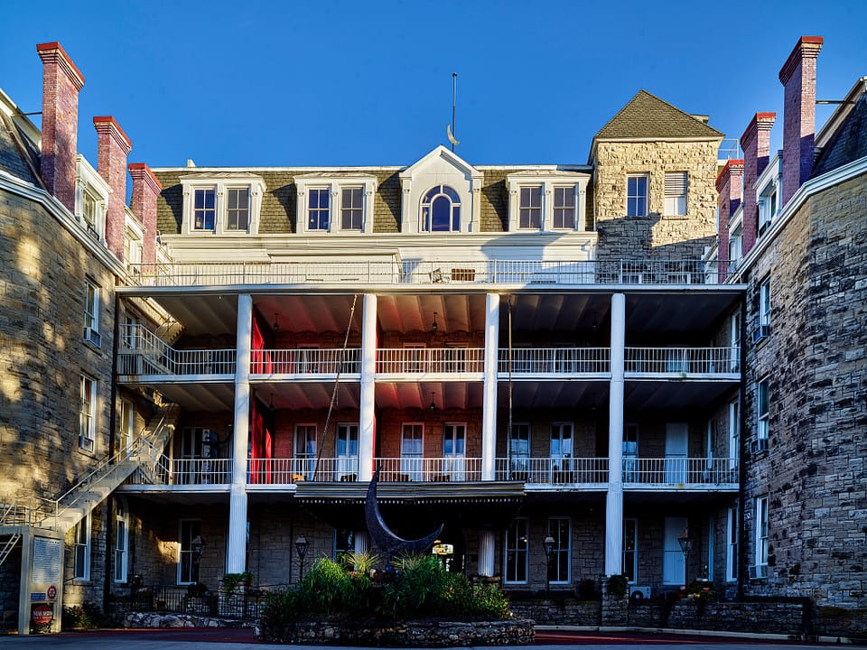 1886 Crescent Hotel exterior in Eureka Springs, Arkansas — historic stone Romanesque Revival hotel viewed from below