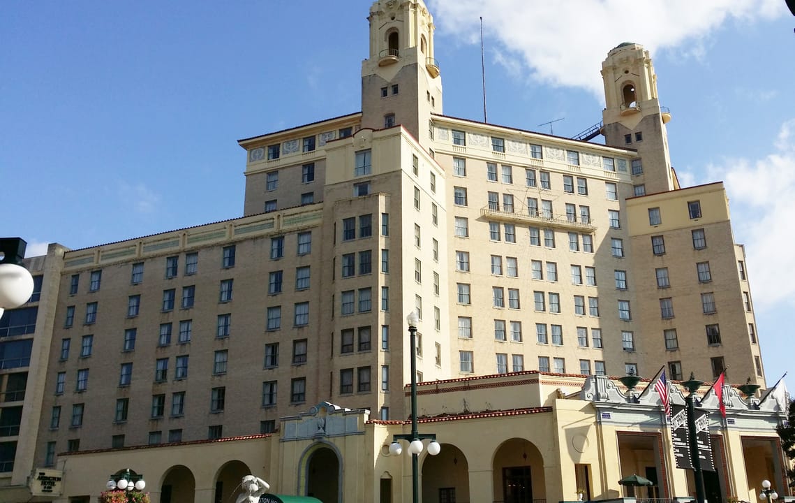 The Arlington Hotel's two towers and arched ground-floor arcade seen from Central Avenue, Hot Springs, Arkansas, October 2015.