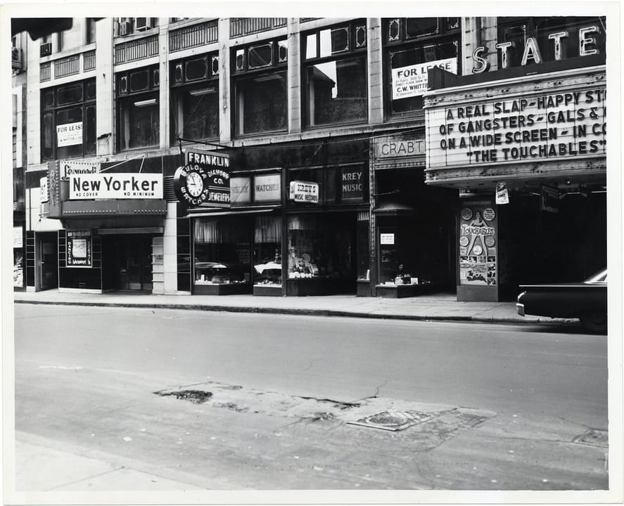 Title: Street scene of downtown Boston showing the New Yorker Lounge, a Jeweler, and a movie theater marquee
Creator: City of Boston
Date: circa 1960-1968
Source: Mayor John F. Collins records, Collection #0244.001
File name: 244001_0891
Rights: Copyright City of Boston
Citation: Mayor John F. Colli