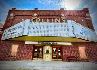 Historic Collins Theatre facade with marquee and red brick exterior in downtown Paragould, Arkansas, a restored 1925 performing arts venue