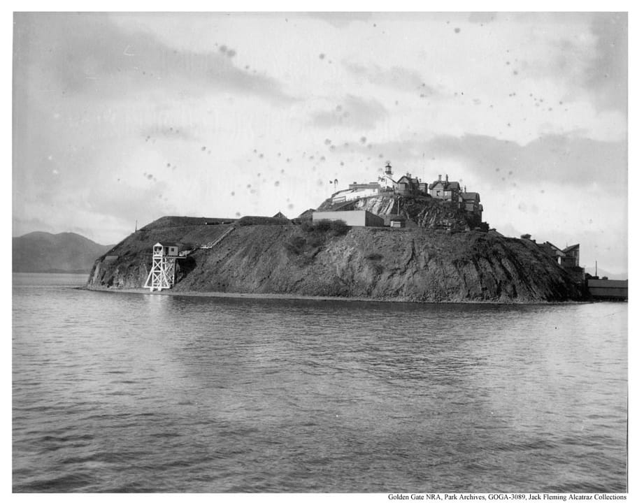 Alcatraz Island seen from the water about 1895, when it was a U.S. Army post, with the lighthouse and quarters on the summit