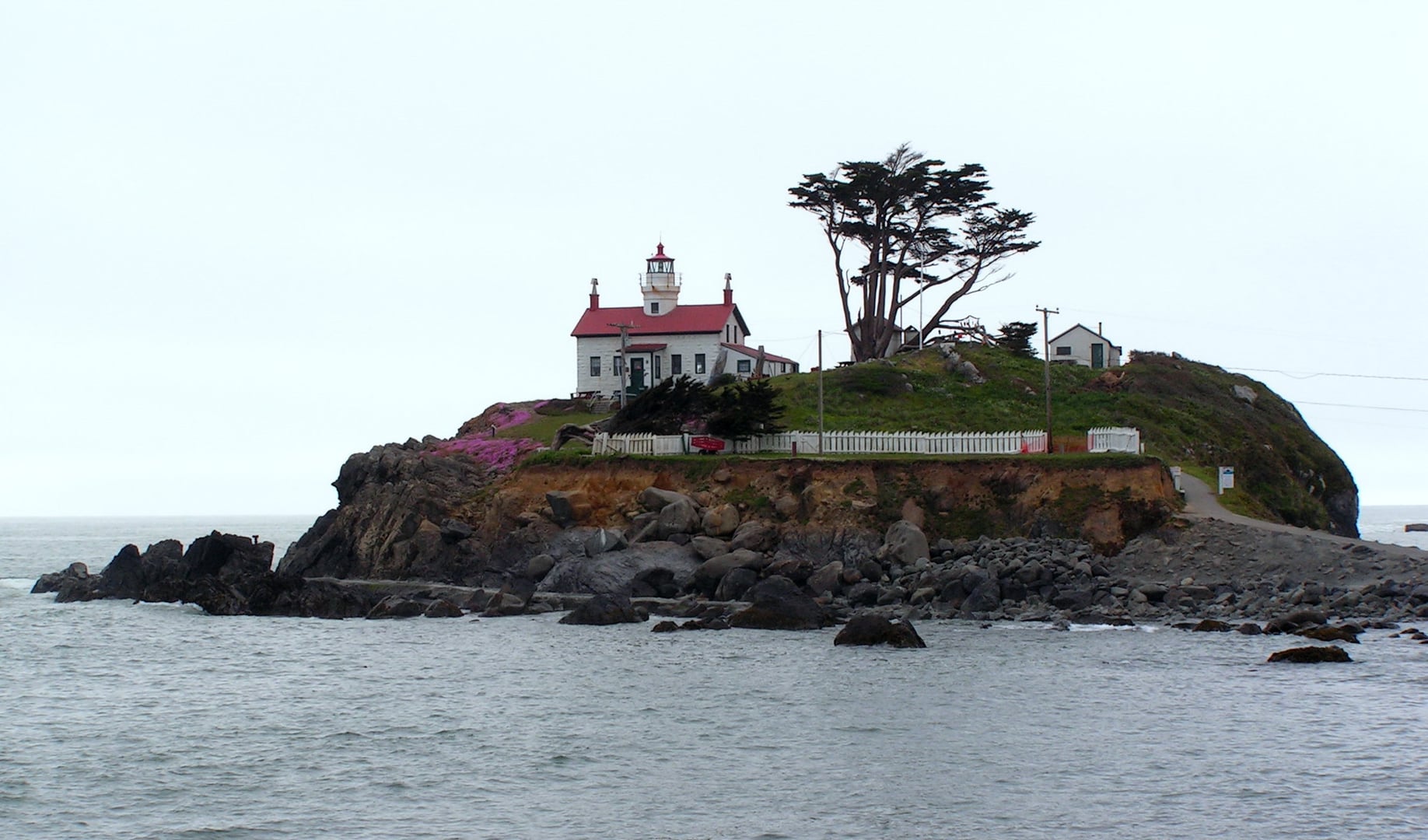 1856 Battery Point Lighthouse on its rocky tidal island off Crescent City, California, with cylindrical tower atop the keeper's house