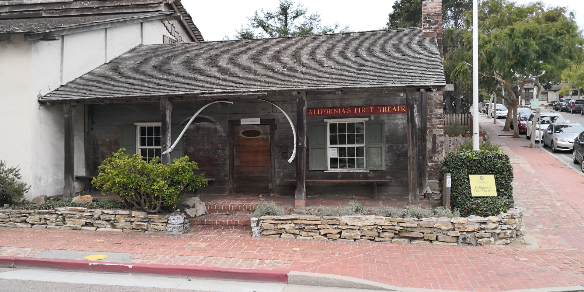 White adobe building with a porch at the corner of Pacific and Scott Streets in Monterey, California