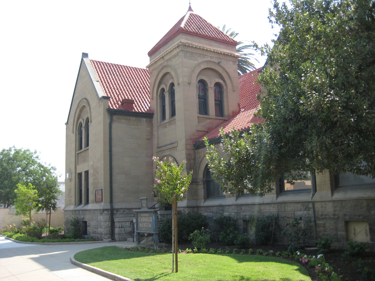 Two-story stone Carnegie library building in Romanesque Revival style