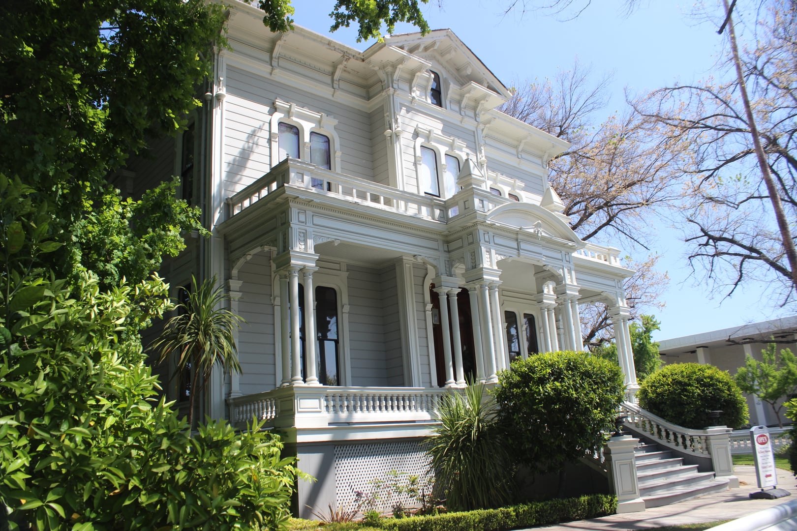 Exterior of the McHenry Mansion in Modesto, California, showing the High Victorian Italianate facade with ornamental woodwork and bay windows