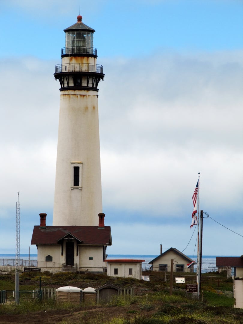 Pigeon Point Lighthouse on the San Mateo coast near Pescadero, California, showing the 115-foot white brick tower against the sky