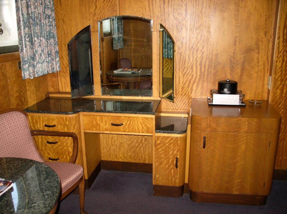 A built-in Art Deco vanity desk and mirror in one of the Queen Mary's original staterooms.