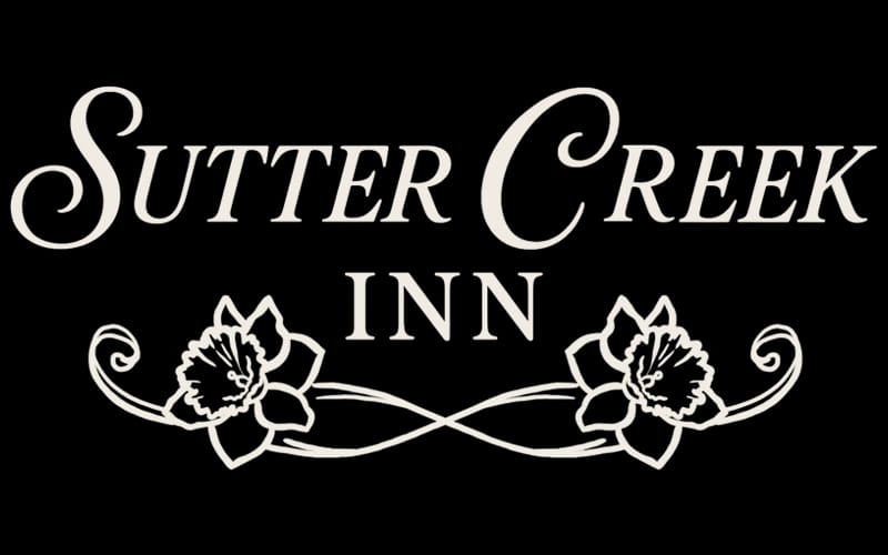 Two-story Greek Revival main house of the Sutter Creek Inn on Main Street in Sutter Creek, California