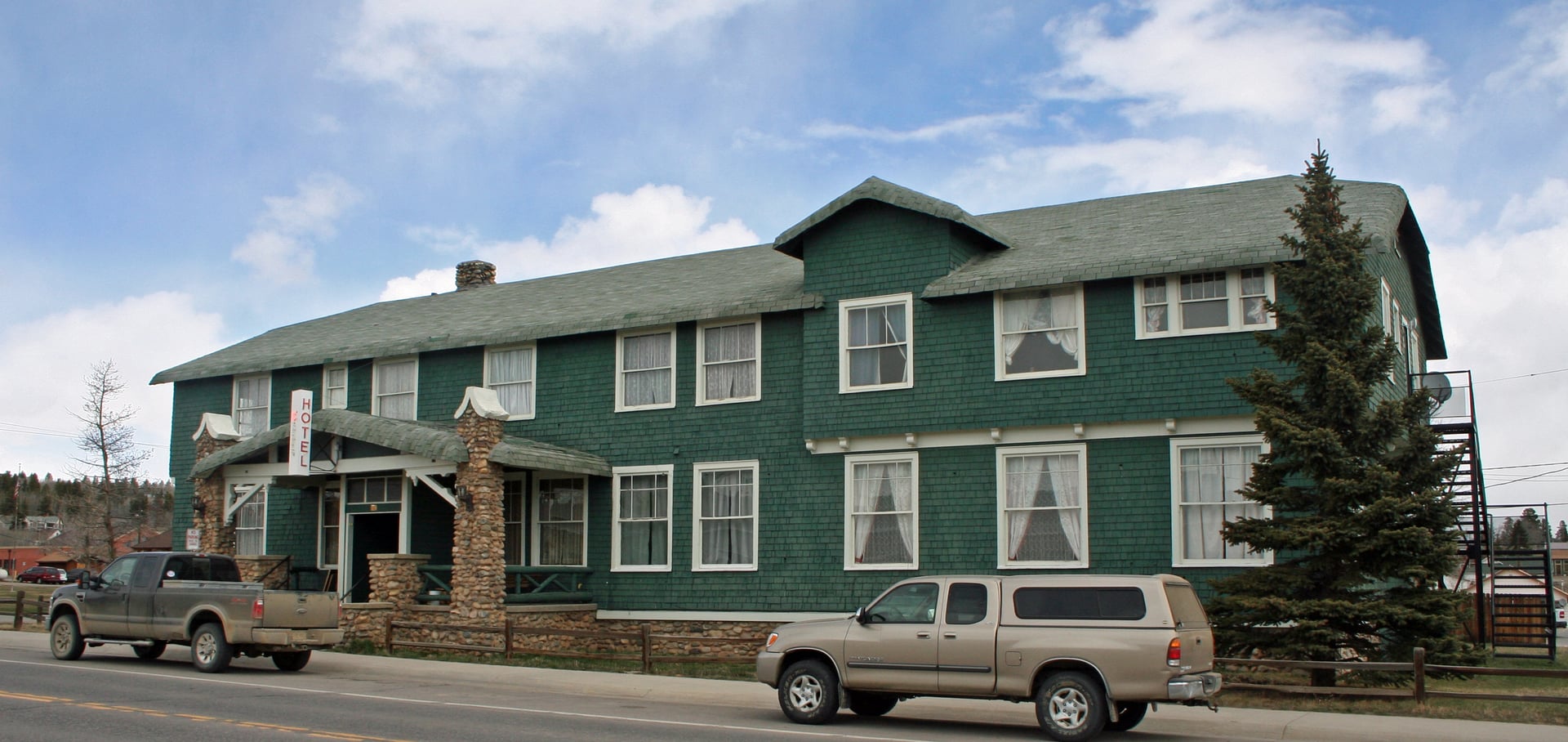 The two-story wood-paneled Hand Hotel at the edge of Fairplay's Front Street, overlooking the South Platte River