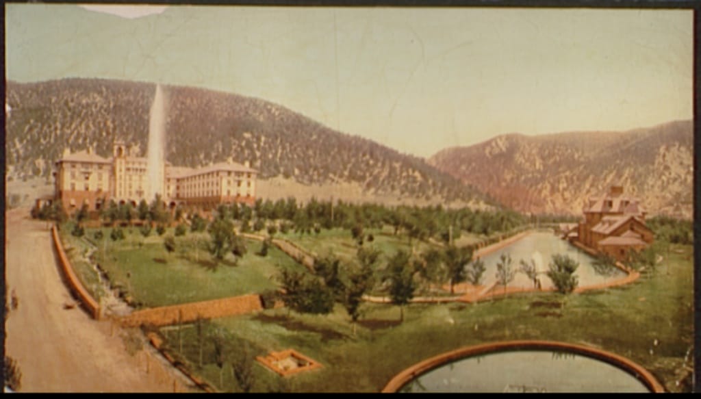 Photochrom postcard view of the Hotel Colorado and its grounds, with the hot-springs geyser spray, fountain, swimming pool and bathhouse in front, circa 1899.
