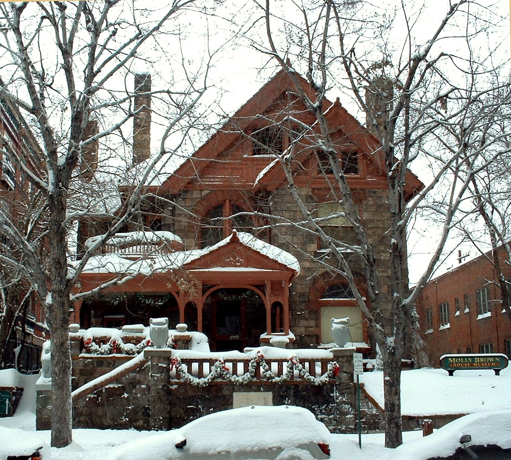 The Queen Anne and Richardsonian Romanesque facade of the Molly Brown House Museum in Denver, Colorado, blanketed in fresh snow