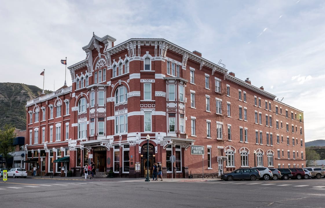 A wide daytime street-corner view of the Strater Hotel, Durango, Colorado.