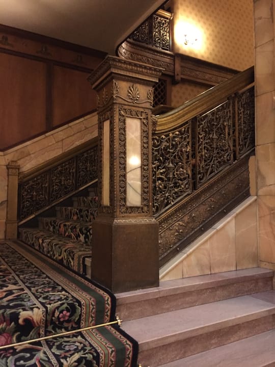 The bronze newel post and carved railing of the Brown Palace Hotel's grand staircase, Denver.