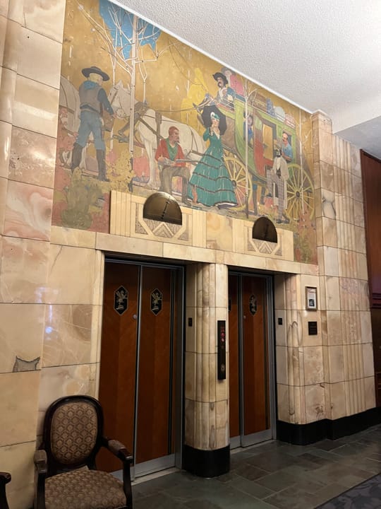 The art-deco mural and elevator lobby inside the Brown Palace Hotel, Denver.