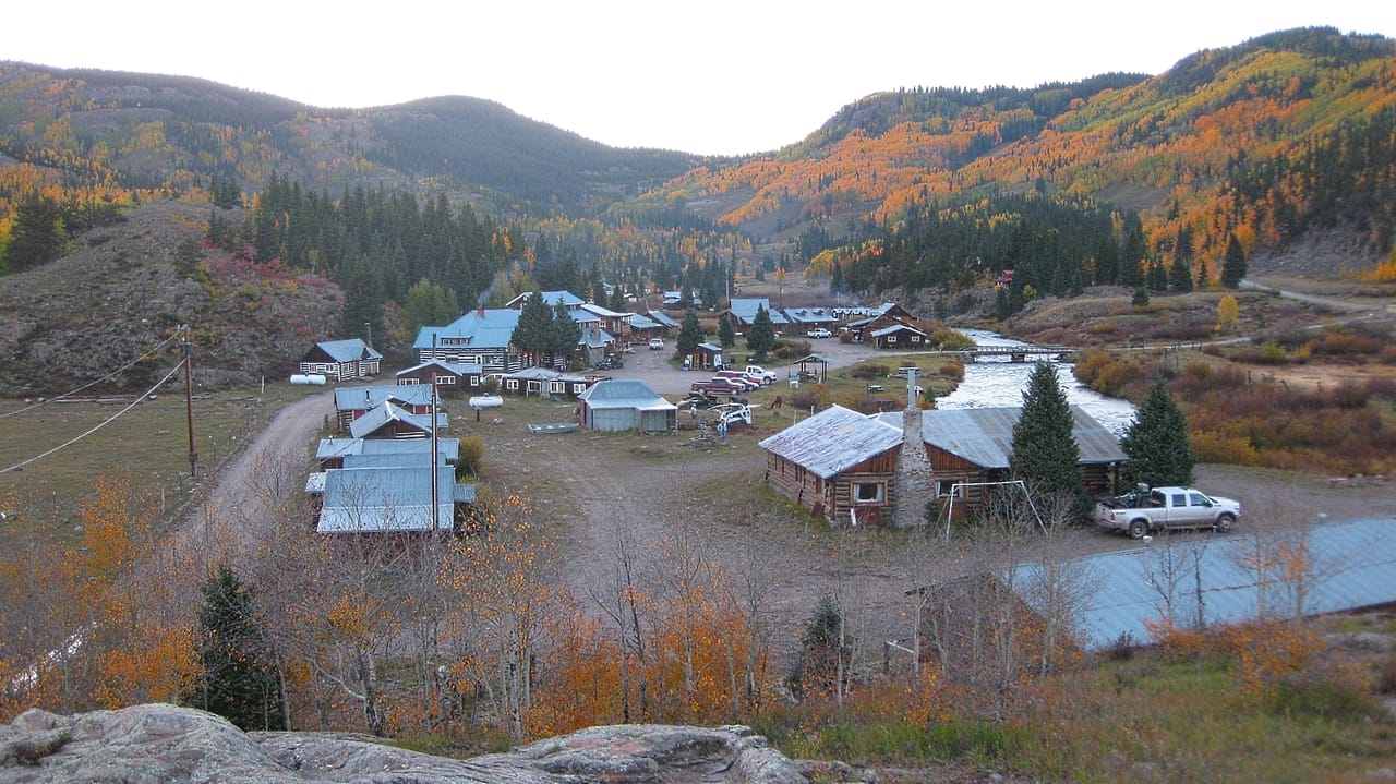 Three-story log lodge in a high-altitude San Juan Mountain valley