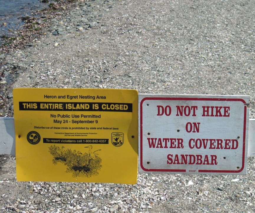 Sign indicating restriction on access to the island via sandbar.