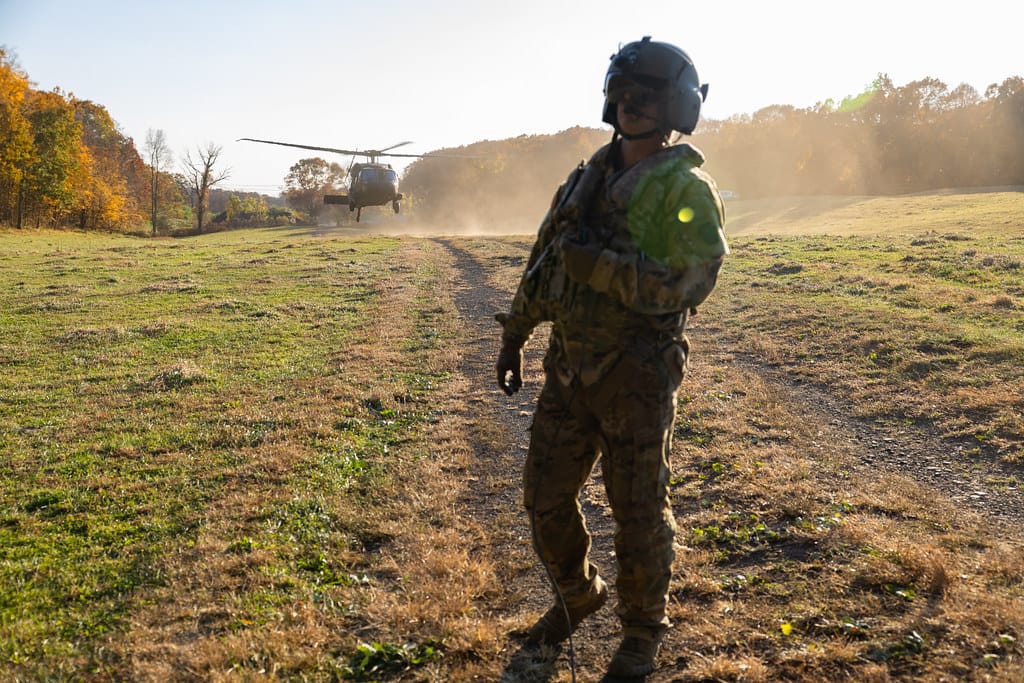 Connecticut Army National Guard Sgt. Adam Osip, a CH-47 helicopter repairer assigned to the 2nd Battalion, 104th Aviation Regiment, performs preflight inspections prior to takeoff simultaneously as a Connecticut Army National Guard UH-60 Black Hawk helicopter from the 1st Battalion, 169th Aviation R