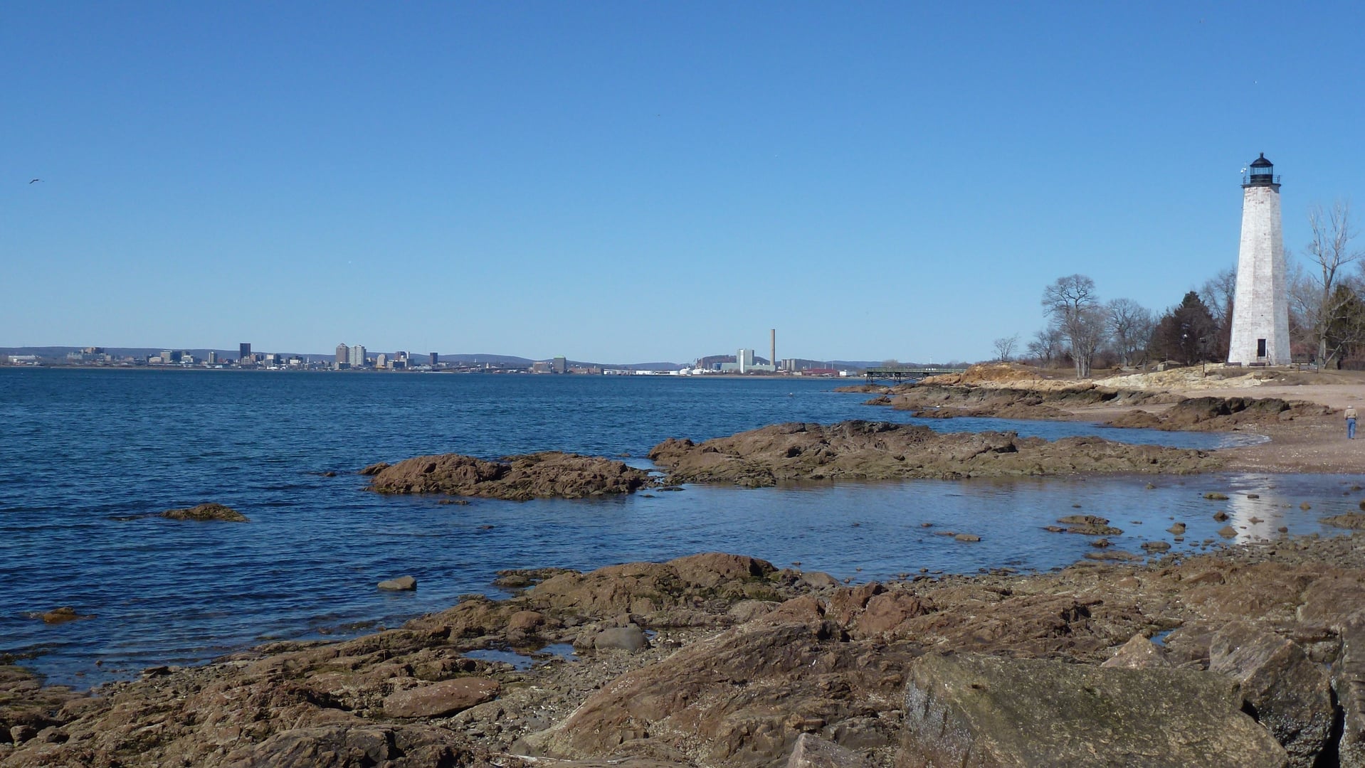 Five Mile Point Light and the downtown New Haven skyline viewed from Lighthouse Point Park, Connecticut.