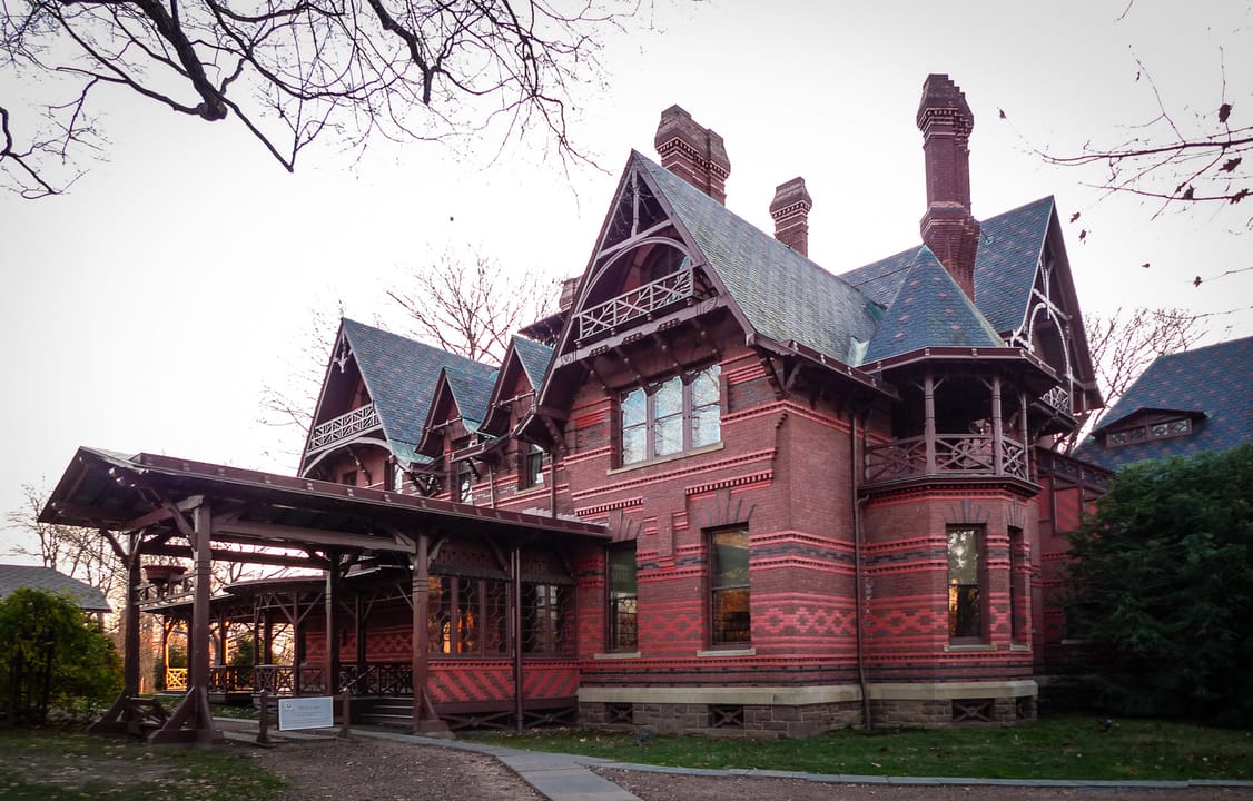 The gabled east facade of the Mark Twain House seen through bare winter trees, Hartford, Connecticut