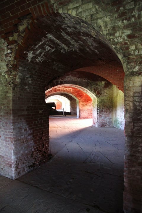 A vaulted brick casemate corridor inside Fort Delaware, open to visitors on the public tour route (2016).