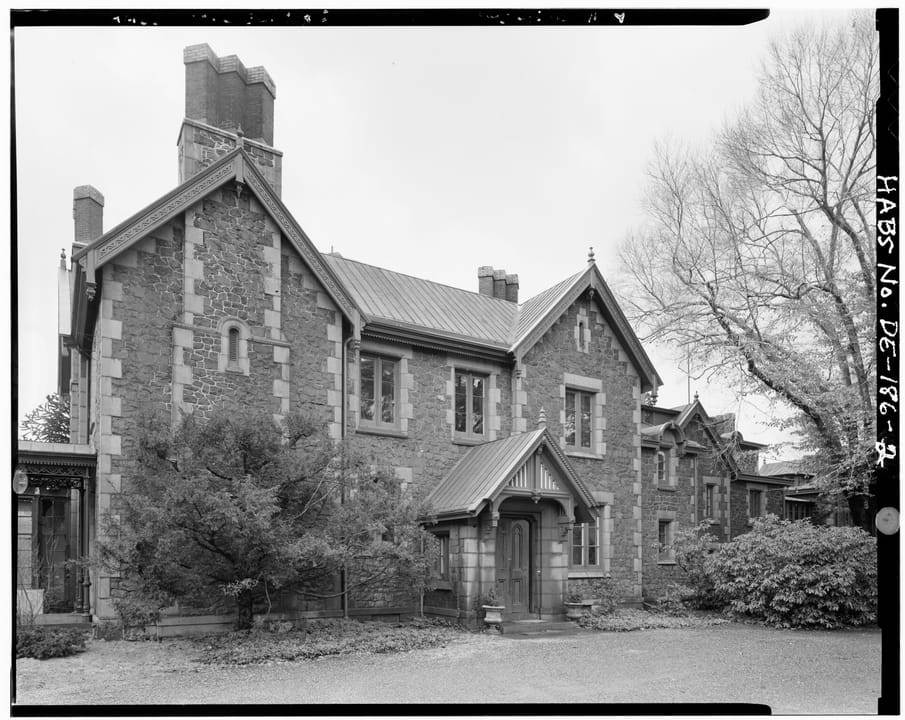Black-and-white Historic American Buildings Survey photograph of Rockwood's stone front elevation and gabled entry porch, Wilmington, Delaware.