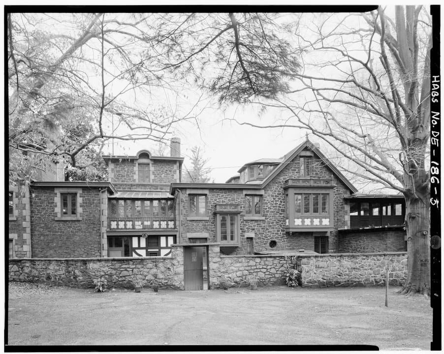 Black-and-white Historic American Buildings Survey photograph of the later service wing and stone courtyard wall at Rockwood, Wilmington, Delaware.