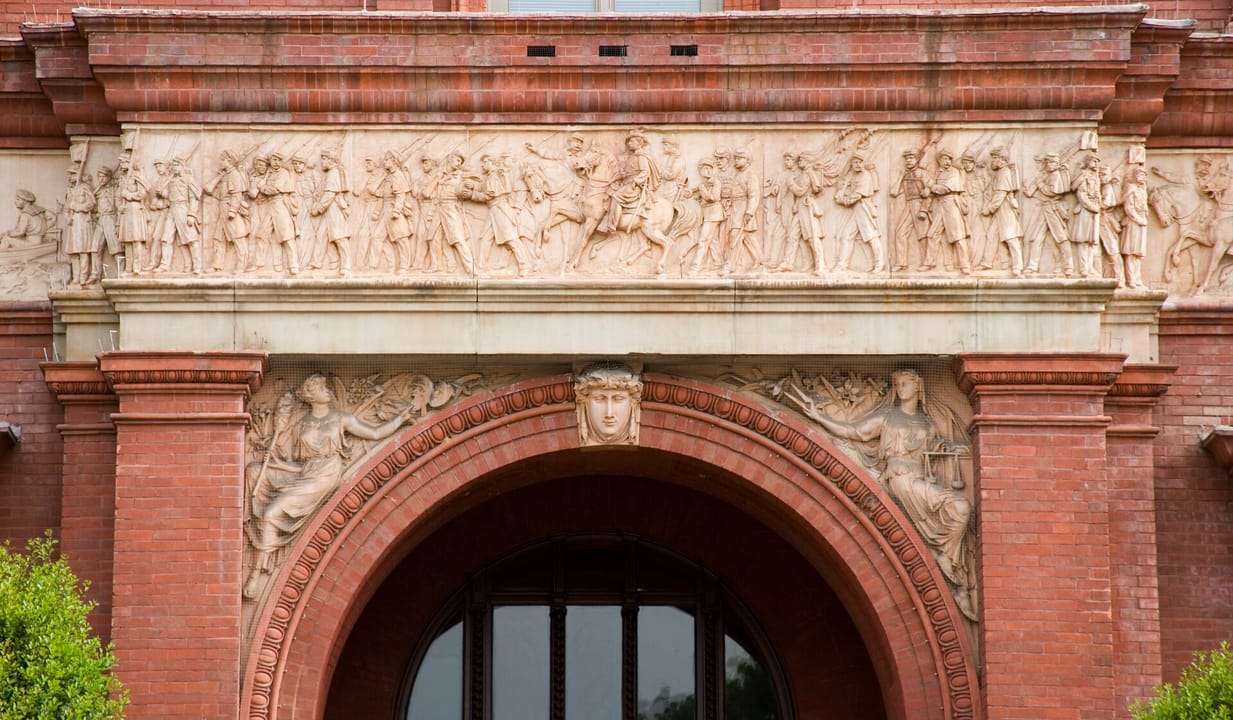 The terra-cotta frieze of Civil War soldiers and sailors circling the National Building Museum's exterior, above the arched entrance.