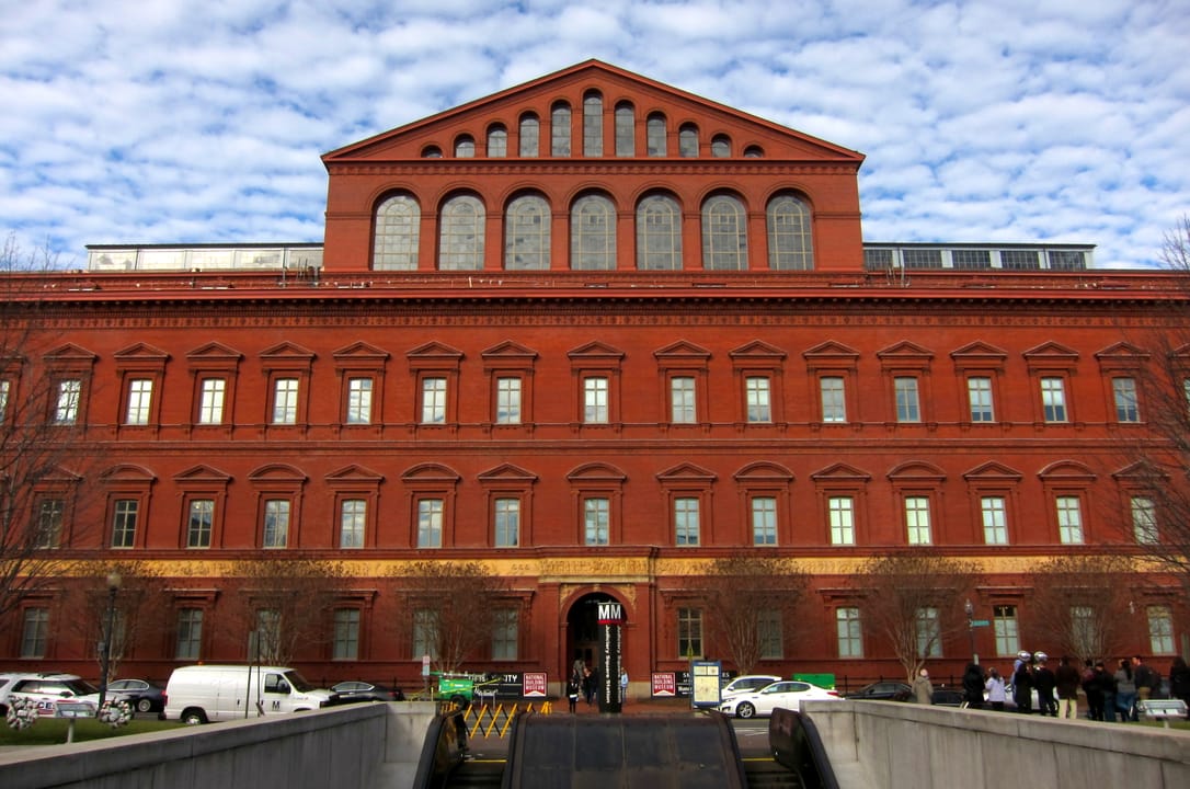 The National Building Museum's red-brick south facade, seen straight-on from F Street.