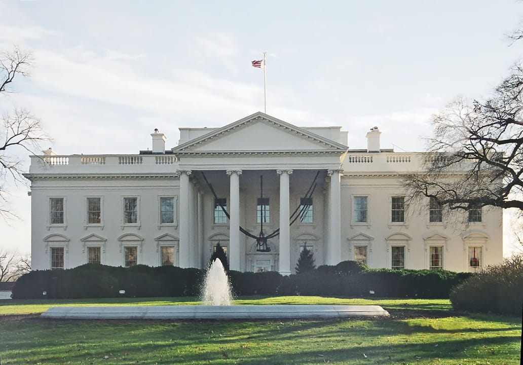 Ground-level view of the White House's north facade in winter, December 2002, bare trees framing the portico.