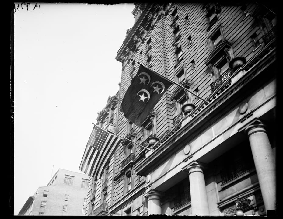 Flags flying from the Willard Hotel's Pennsylvania Avenue cornice, with its colonnaded entrance below, 1924.