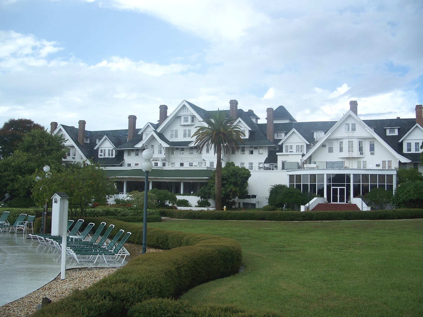 Exterior of the Belleview-Biltmore Hotel in Belleair Florida, white wooden Queen Anne facade with green roof