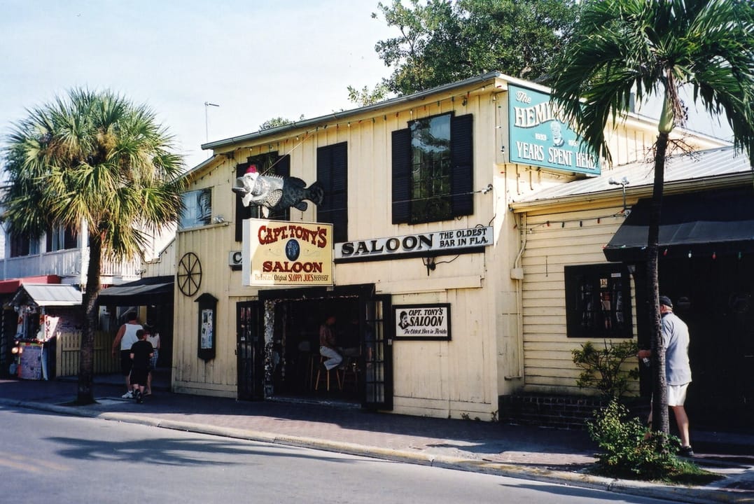 Captain Tony's Saloon in December 2002, an older exterior view of the same weathered yellow building, Key West