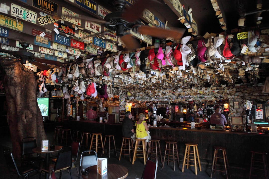 Inside Captain Tony's Saloon, showing the famously decorated ceiling of license plates and patrons' bras above the bar, Key West