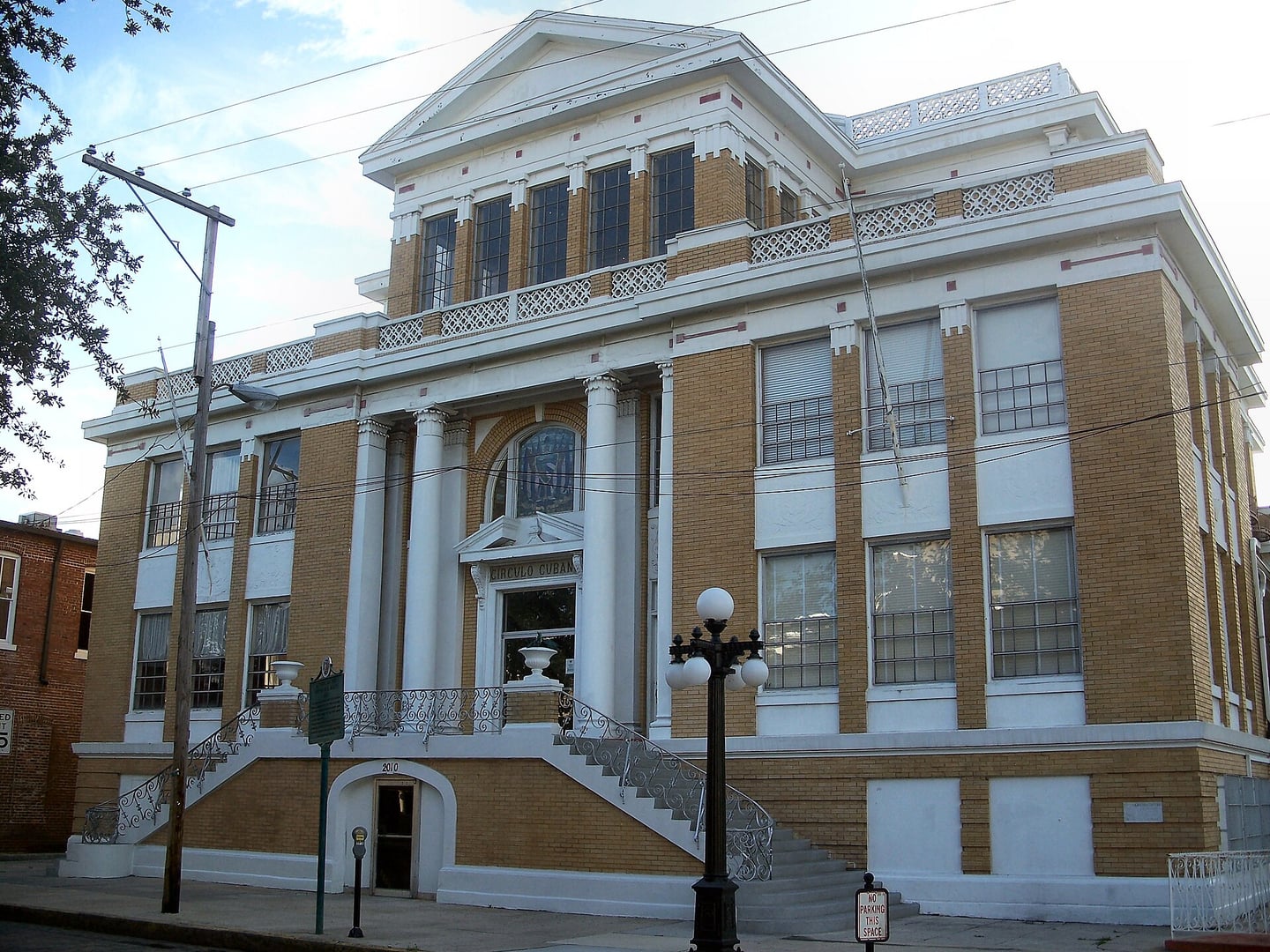 Exterior facade of The Cuban Club (El Circulo Cubano de Tampa) in Ybor City, a 1917 Neoclassical brick clubhouse with grand arched windows and ornamental columns.