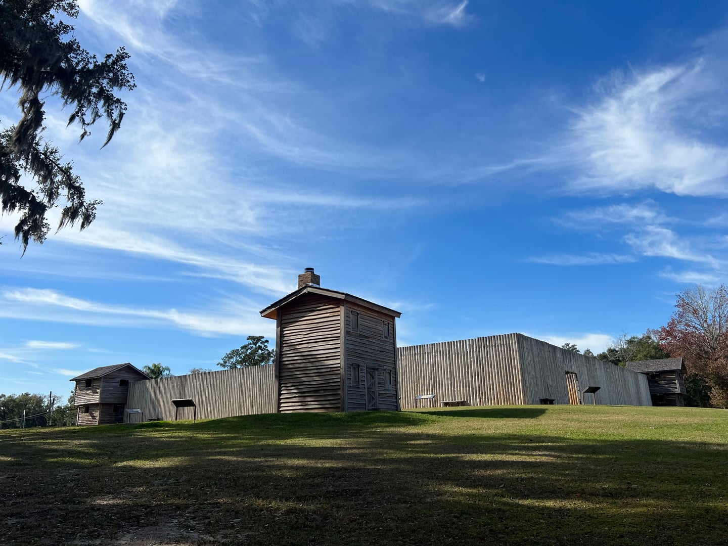 The reconstructed Fort King fortress in Ocala Florida, a wooden palisade structure surrounded by trees
