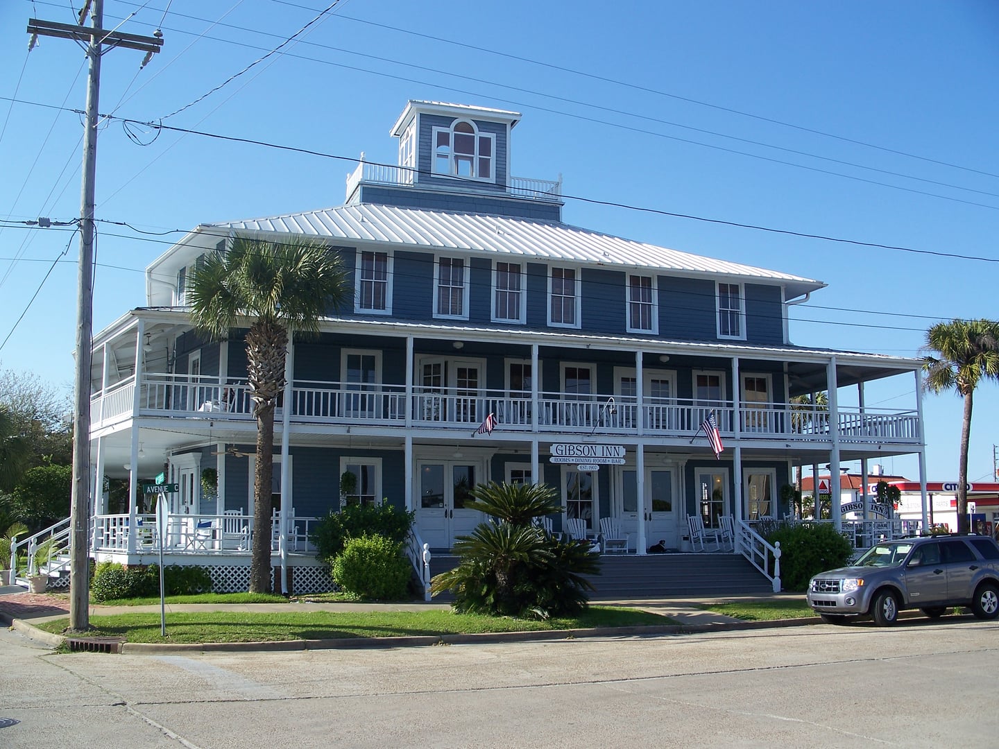 Exterior of the historic Gibson Inn, a three-story Victorian wood-frame inn in the Apalachicola Historic District, Florida