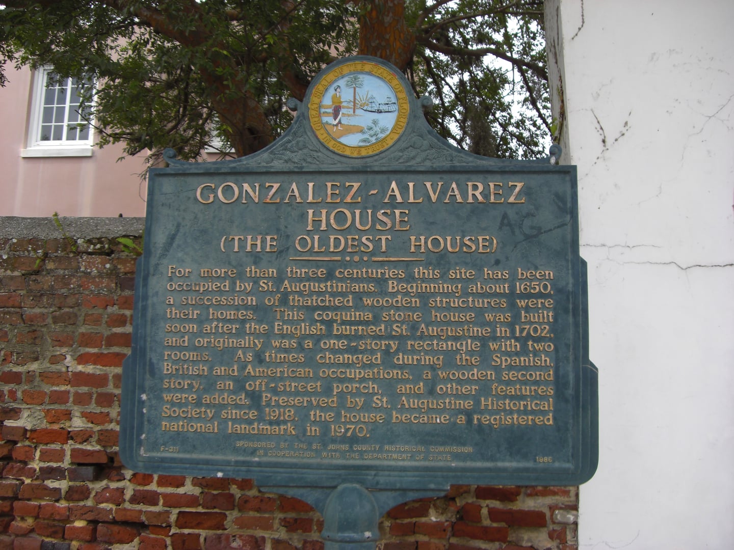 Exterior of the González-Álvarez House (The Oldest House) at 14 St. Francis Street in St. Augustine, Florida, showing the coquina lower walls and wood-frame upper story