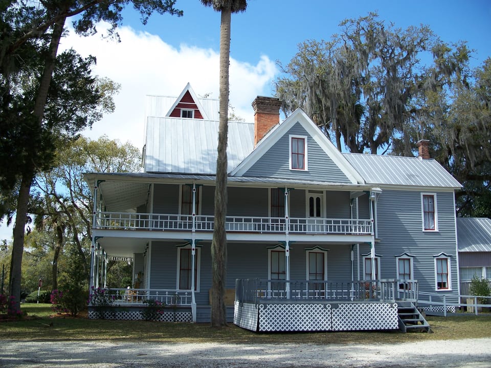 The May-Stringer House viewed from the grounds, showing the opposite side of the house and the gravel drive, Brooksville, Florida.