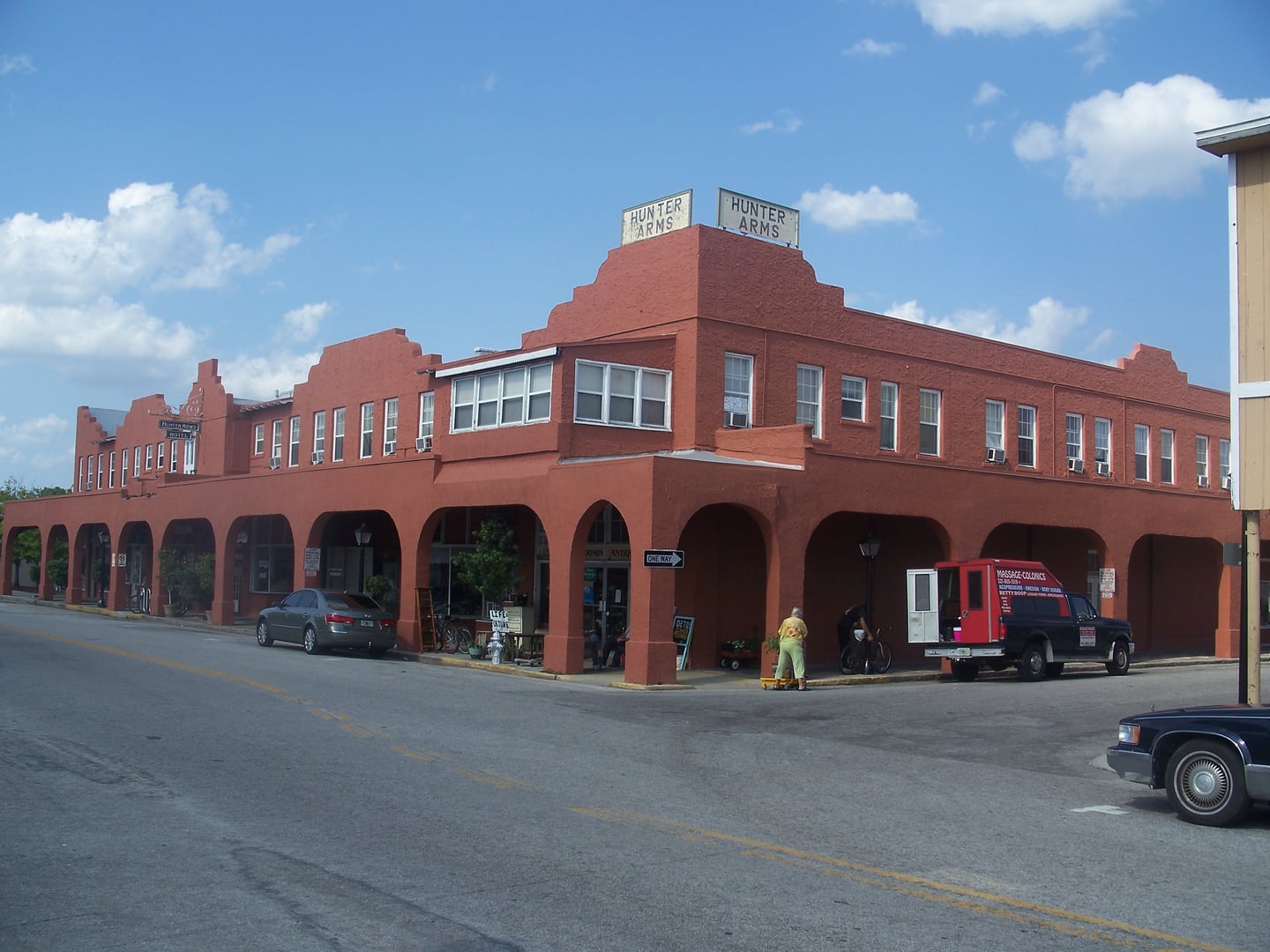 Mediterranean Revival hotel with stucco walls, red tile roof, and arched windows in downtown St. Cloud, Florida